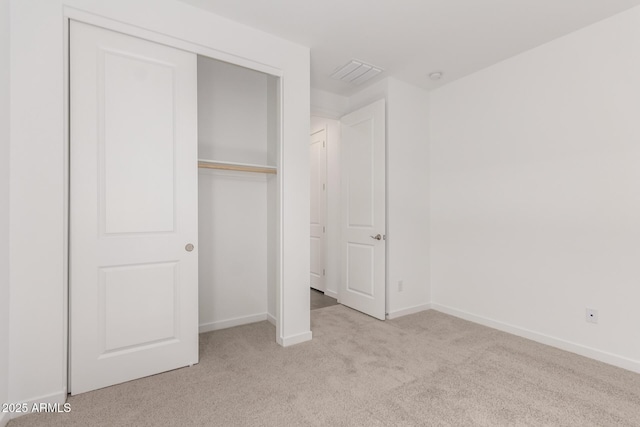unfurnished bedroom featuring visible vents, baseboards, and carpet