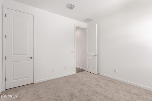 unfurnished bedroom with baseboards, visible vents, and carpet floors