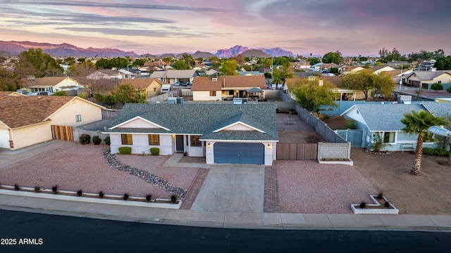 view of front of property with a garage and a mountain view