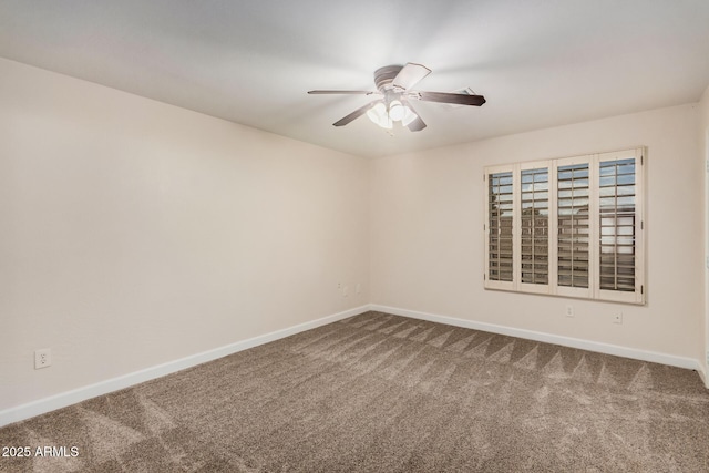 carpeted spare room featuring baseboards and ceiling fan