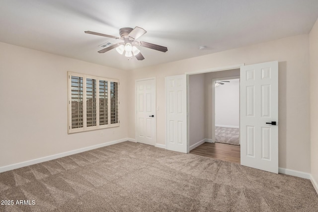 unfurnished bedroom with carpet floors, baseboards, and ceiling fan