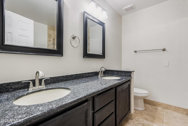 full bathroom with toilet, double vanity, tile patterned flooring, and baseboards