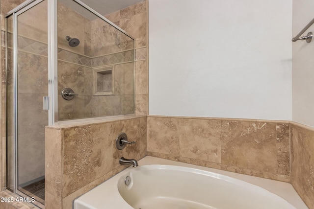 bathroom with a shower stall and a garden tub