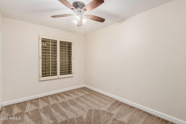 empty room with carpet floors, baseboards, and a ceiling fan