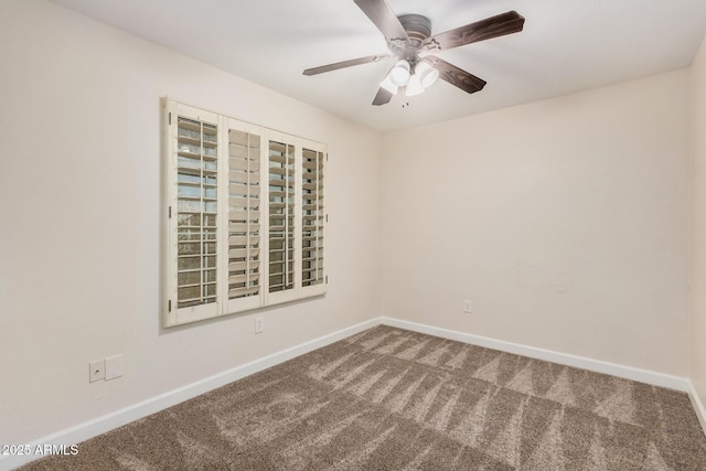 carpeted empty room featuring baseboards and ceiling fan
