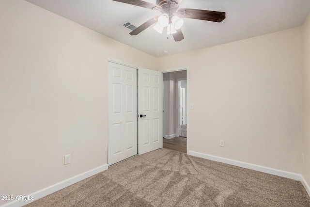 unfurnished bedroom featuring carpet, baseboards, and ceiling fan