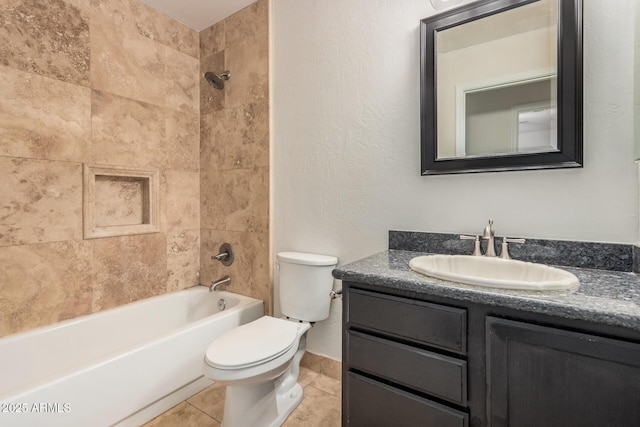 bathroom with toilet, vanity, tile patterned floors, shower / washtub combination, and a textured wall