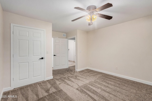 unfurnished bedroom with carpet, baseboards, and ceiling fan