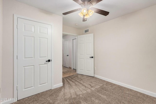 unfurnished bedroom featuring carpet flooring, baseboards, and a ceiling fan