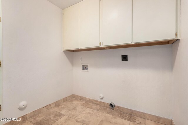 clothes washing area featuring gas dryer hookup, baseboards, washer hookup, electric dryer hookup, and cabinet space