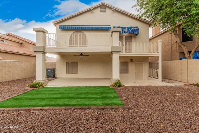 back of house featuring a balcony, a ceiling fan, central AC unit, and stucco siding