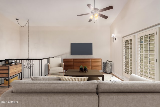 living room featuring vaulted ceiling, ceiling fan, and wood finished floors