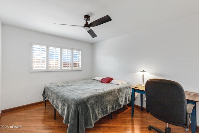 bedroom with baseboards, wood finished floors, and a ceiling fan