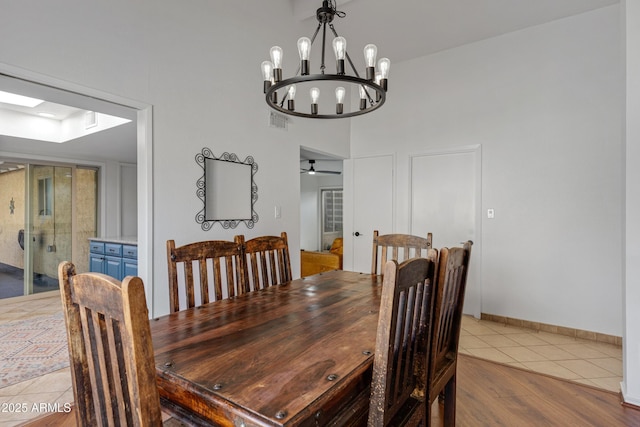 dining room featuring visible vents, ceiling fan, and wood finished floors