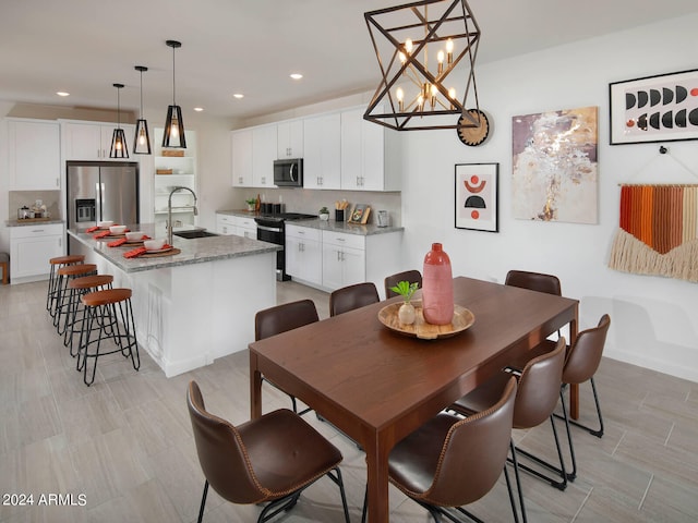 dining room featuring a chandelier and sink