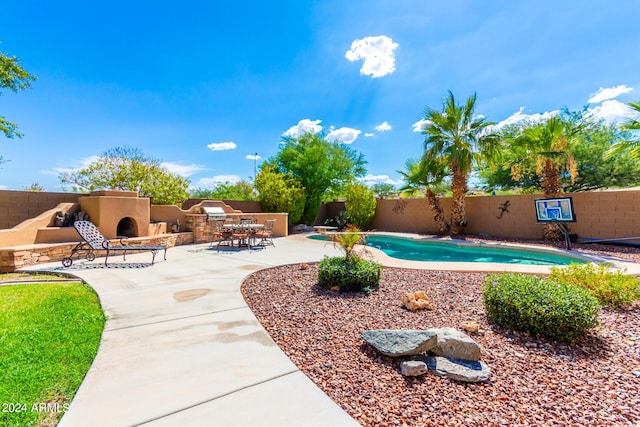 view of pool with a patio area and an outdoor stone fireplace