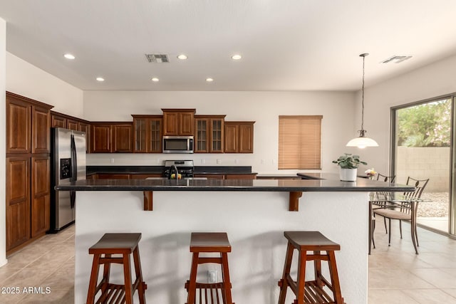 2600 E Hazeltine Way, Chandler, AZ 85249 - kitchen with a breakfast bar area, visible vents, and stainless steel appliances