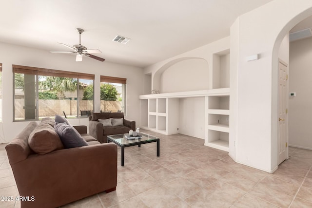2600 E Hazeltine Way, Chandler, AZ 85249 - living area featuring visible vents, ceiling fan, built in shelves, arched walkways, and light tile patterned floors