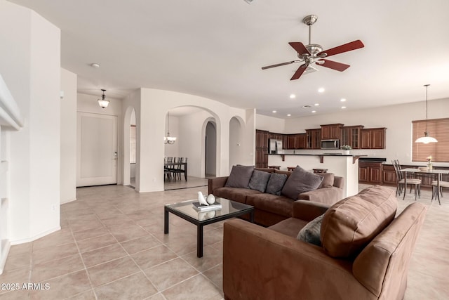 2600 E Hazeltine Way, Chandler, AZ 85249 - living room featuring light tile patterned floors, arched walkways, recessed lighting, and a ceiling fan