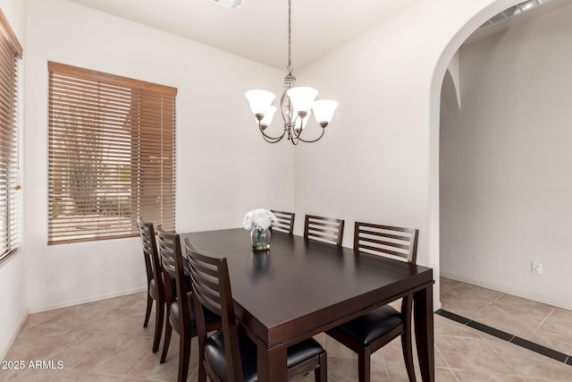 2600 E Hazeltine Way, Chandler, AZ 85249 - dining room with light tile patterned floors, arched walkways, baseboards, and a notable chandelier