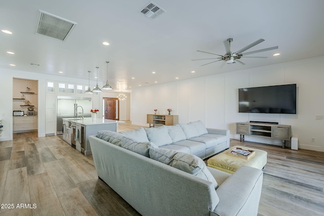 22709 S 202nd St, Queen Creek, AZ 85142 - living room with light wood-style floors, ceiling fan, a chandelier, and recessed lighting