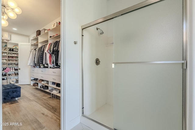 22709 S 202nd St, Queen Creek, AZ 85142 - bathroom with a stall shower, a walk in closet, and wood finished floors