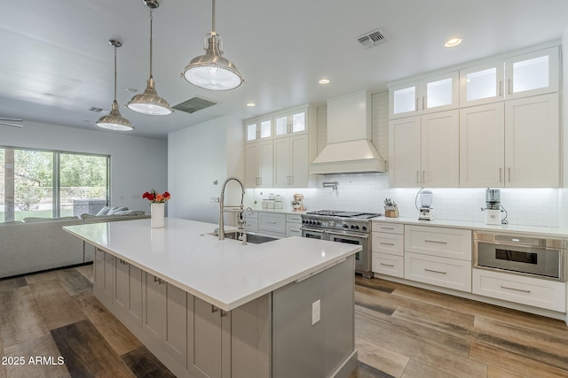 22709 S 202nd St, Queen Creek, AZ 85142 - kitchen with custom range hood, appliances with stainless steel finishes, a sink, open floor plan, and backsplash