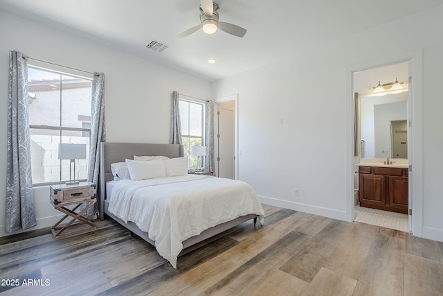 22709 S 202nd St, Queen Creek, AZ 85142 - bedroom featuring light wood finished floors, a sink, ensuite bathroom, baseboards, and a ceiling fan