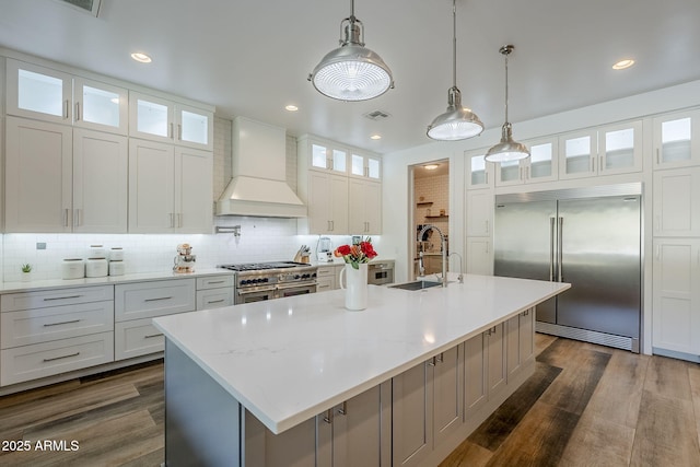22709 S 202nd St, Queen Creek, AZ 85142 - kitchen with premium appliances, premium range hood, a sink, decorative backsplash, and an island with sink
