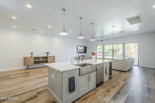 22709 S 202nd St, Queen Creek, AZ 85142 - kitchen with a sink, stainless steel dishwasher, a center island with sink, light wood-type flooring, and recessed lighting