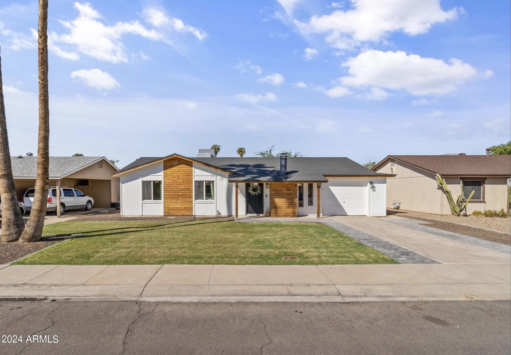 single story home with a garage and a front lawn