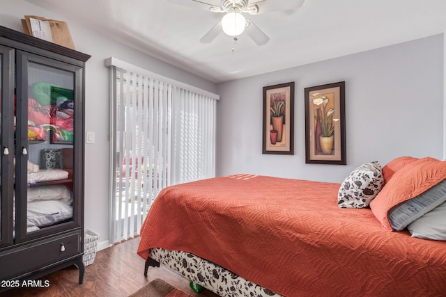 bedroom featuring ceiling fan, wood-type flooring, and access to exterior