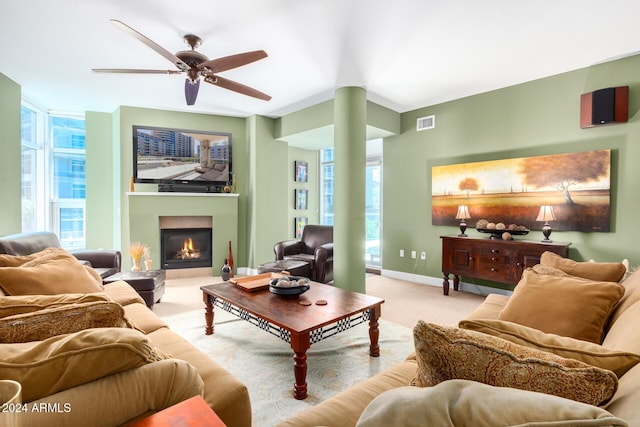 120 E Rio Salado Pkwy Unit 201, Tempe, AZ 85281 - carpeted living area with baseboards, a warm lit fireplace, ceiling fan, and plenty of natural light