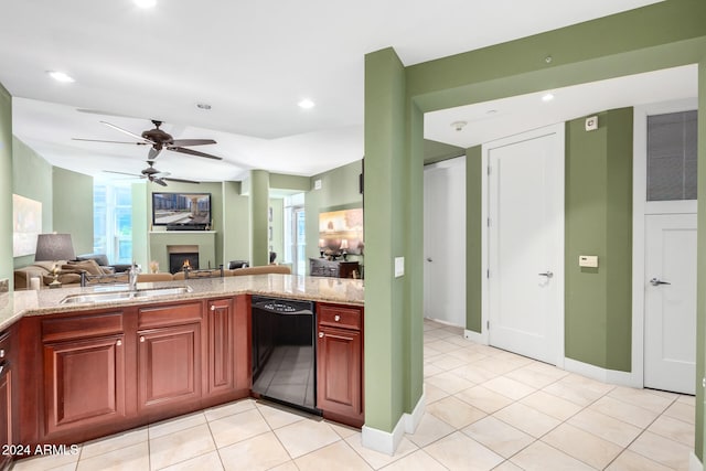 kitchen with dishwasher, sink, ceiling fan, and light stone countertops