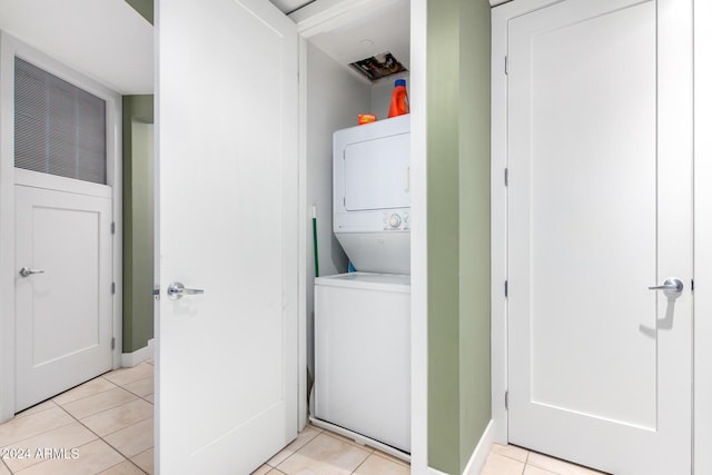 120 E Rio Salado Pkwy Unit 201, Tempe, AZ 85281 - laundry room featuring stacked washer / drying machine, light tile patterned floors, and baseboards