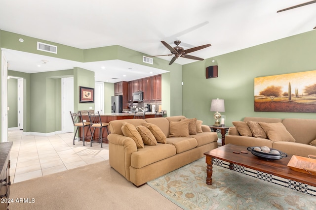 living room featuring light tile patterned floors and ceiling fan