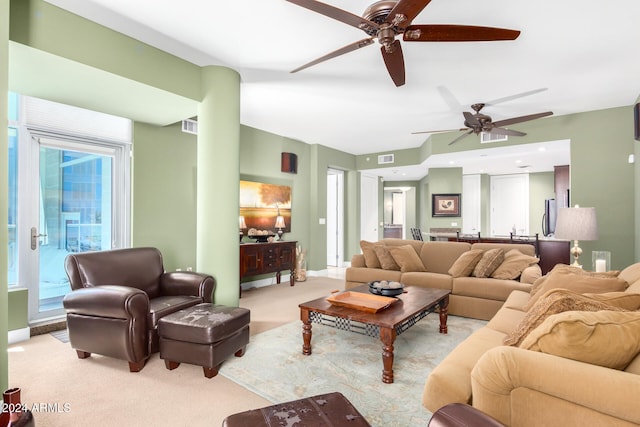 carpeted living room featuring ceiling fan and plenty of natural light