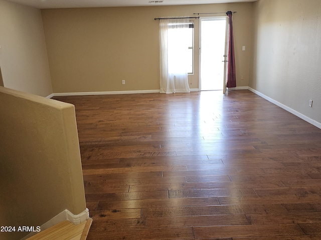 empty room with dark hardwood / wood-style floors