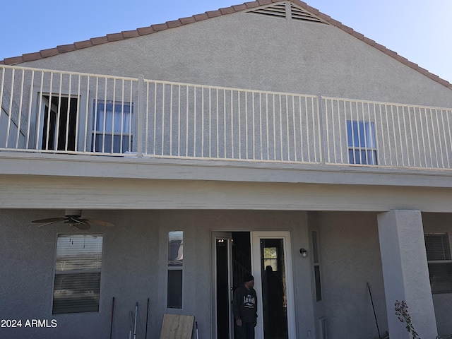 exterior space featuring ceiling fan and a balcony