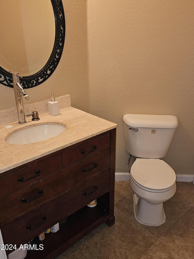 bathroom with tile patterned floors, vanity, and toilet