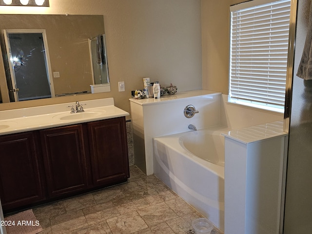 bathroom with a bathing tub and vanity