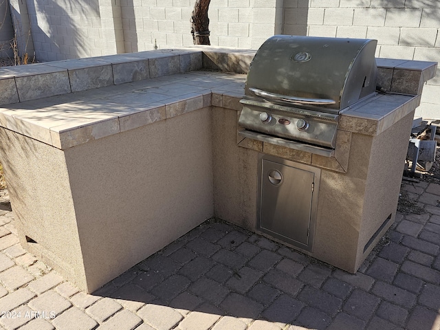 view of patio featuring area for grilling and a grill