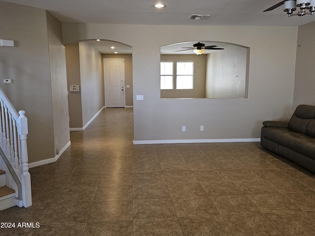 unfurnished living room with ceiling fan