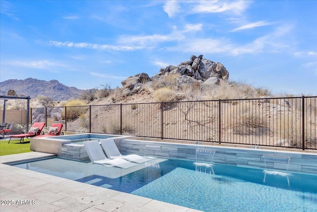 view of swimming pool with a mountain view, a fenced in pool, an in ground hot tub, and fence