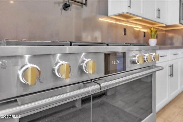 details featuring stainless steel stove and white cabinets