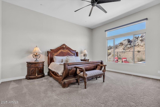 carpeted bedroom featuring baseboards and a ceiling fan