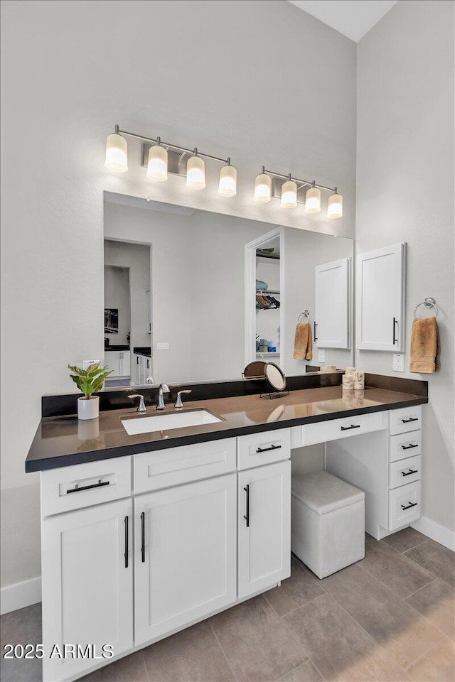 bathroom with baseboards and vanity