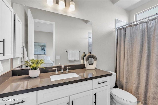 bathroom with a shower with shower curtain, toilet, and vanity