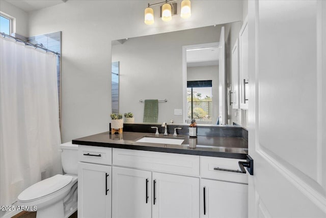 full bathroom with vanity, curtained shower, and toilet