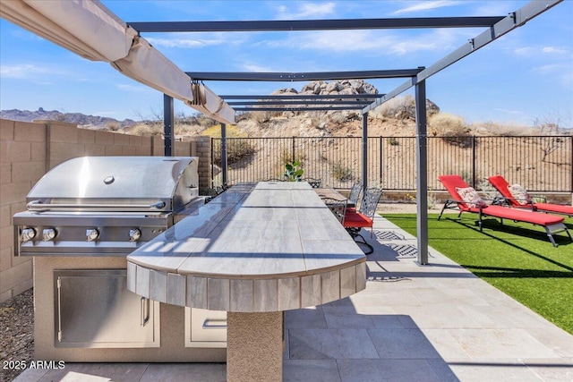 view of patio / terrace featuring area for grilling, outdoor dining area, a fenced backyard, and a grill